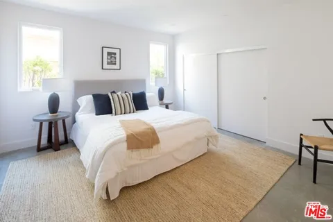 a bed room with a bed and a chair