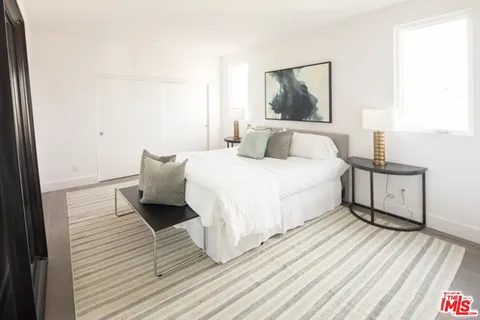 a bedroom with a bed and a night stand