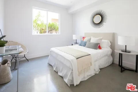 a bedroom with bed and a window