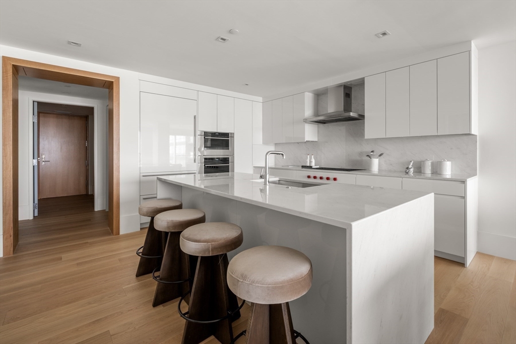 150 Seaport Boulevard, Unit 15CD Boston, MA 02210 - Photo 13 of 39 a kitchen with stainless steel appliances a sink stove and cabinets