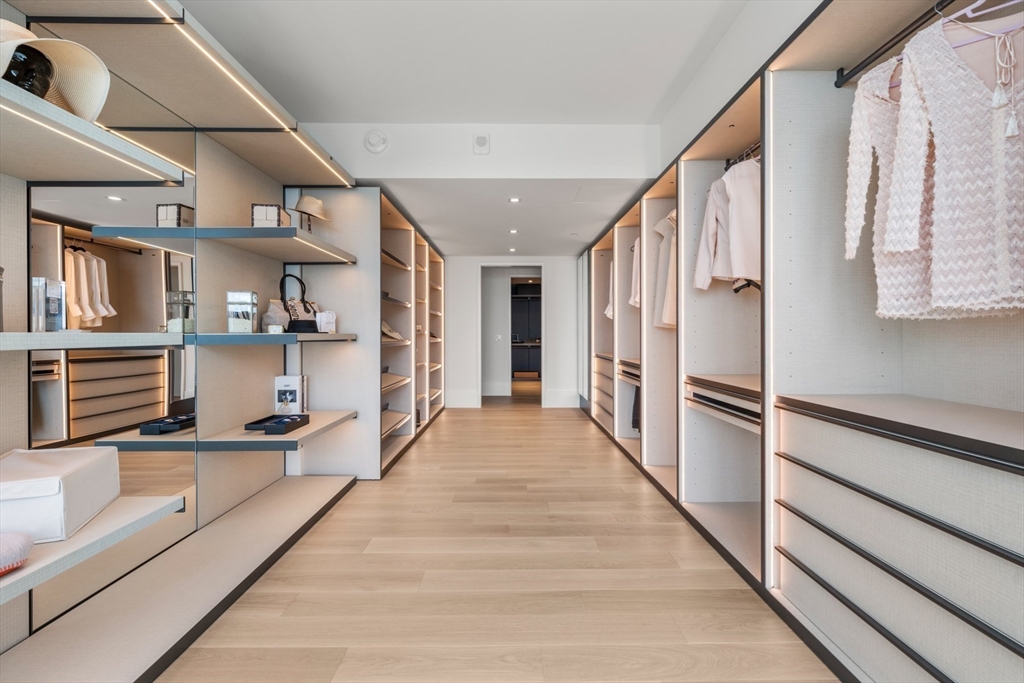 150 Seaport Boulevard, Unit 15CD Boston, MA 02210 - Photo 19 of 39 a view of a hallway with wooden floor and staircase