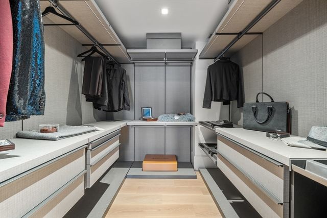 a large white kitchen with a large window and stainless steel appliances