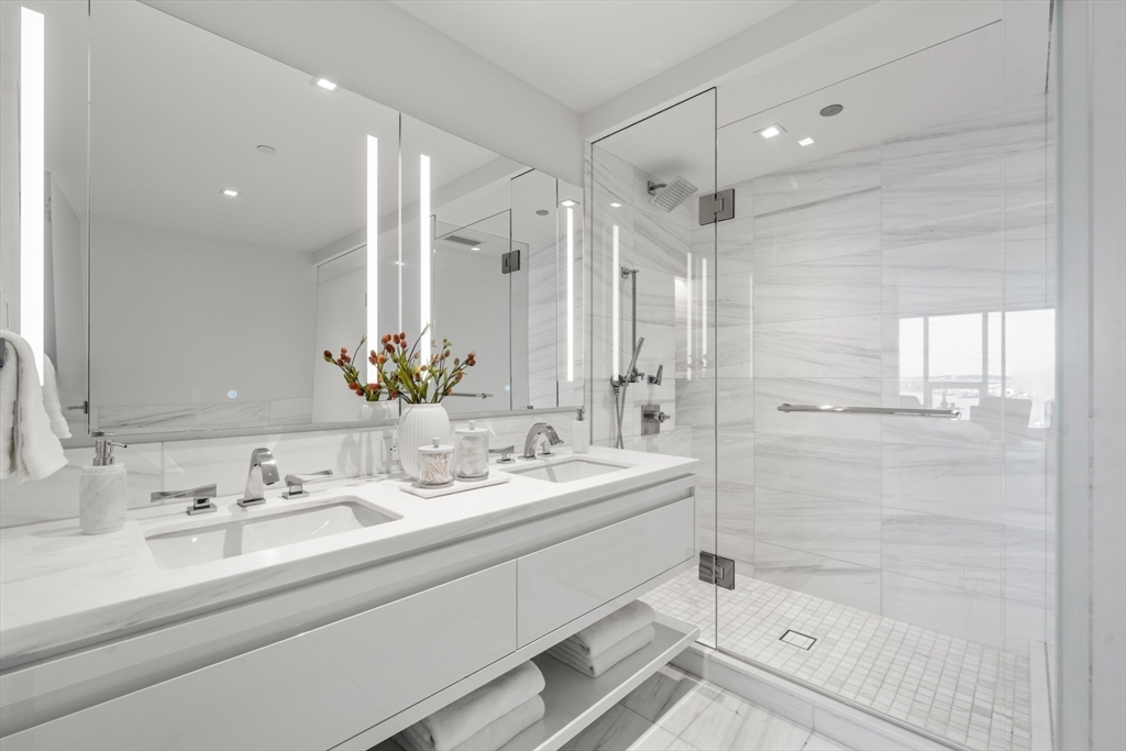 150 Seaport Boulevard, Unit 15CD Boston, MA 02210 - Photo 26 of 39 a bathroom with a double vanity sink mirror double and shower