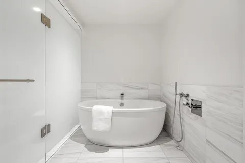 a bathroom with a double vanity sink mirror and shower