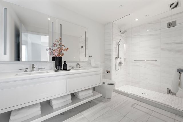 a sink with white cabinets