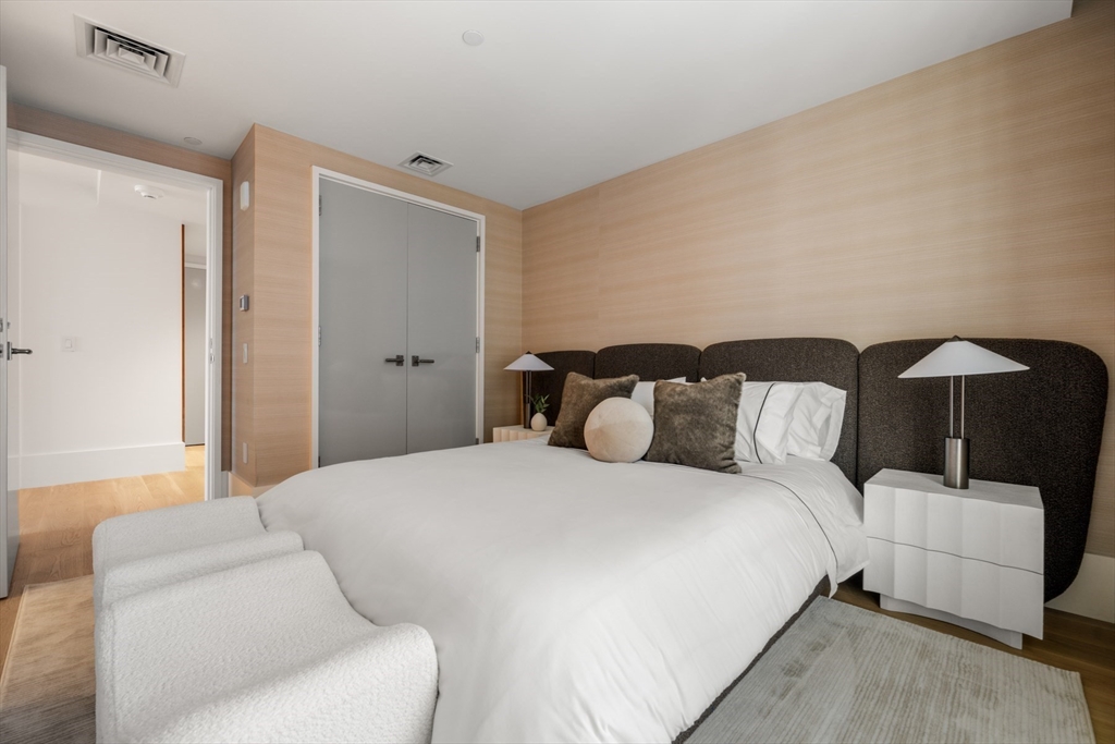 150 Seaport Boulevard, Unit 15CD Boston, MA 02210 - Photo 31 of 39 a bedroom with a bed and a couch