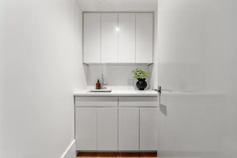 a view of a large building with swimming pool and ocean view