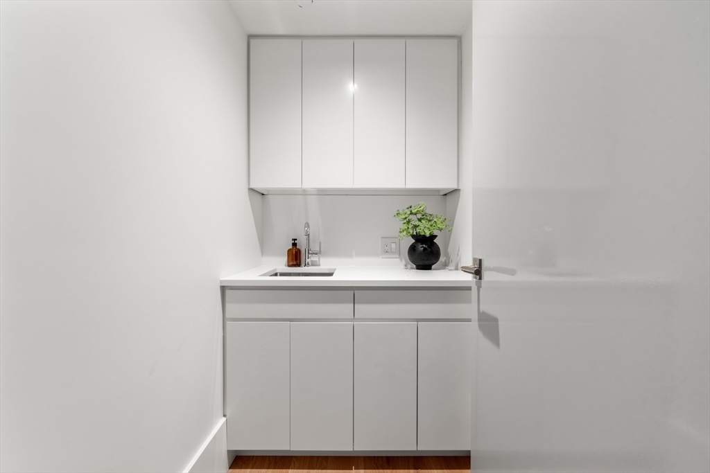 150 Seaport Boulevard, Unit 15CD Boston, MA 02210 - Photo 32 of 39 a sink with white cabinets
