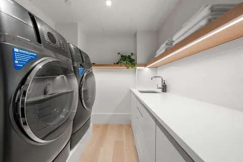 a living room with furniture a floor to ceiling window and a flat screen tv