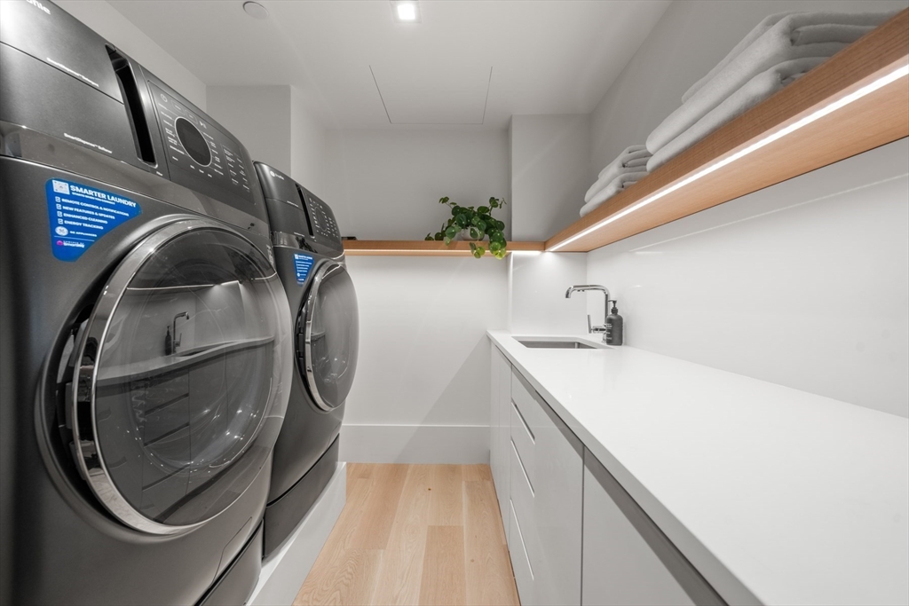 150 Seaport Boulevard, Unit 15CD Boston, MA 02210 - Photo 33 of 39 a utility room with dryer and washer