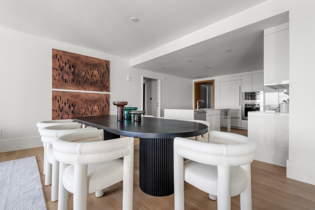 150 Seaport Boulevard, Unit 15CD Boston, MA 02210 - Photo 7 of 39 a view of a dining room with furniture