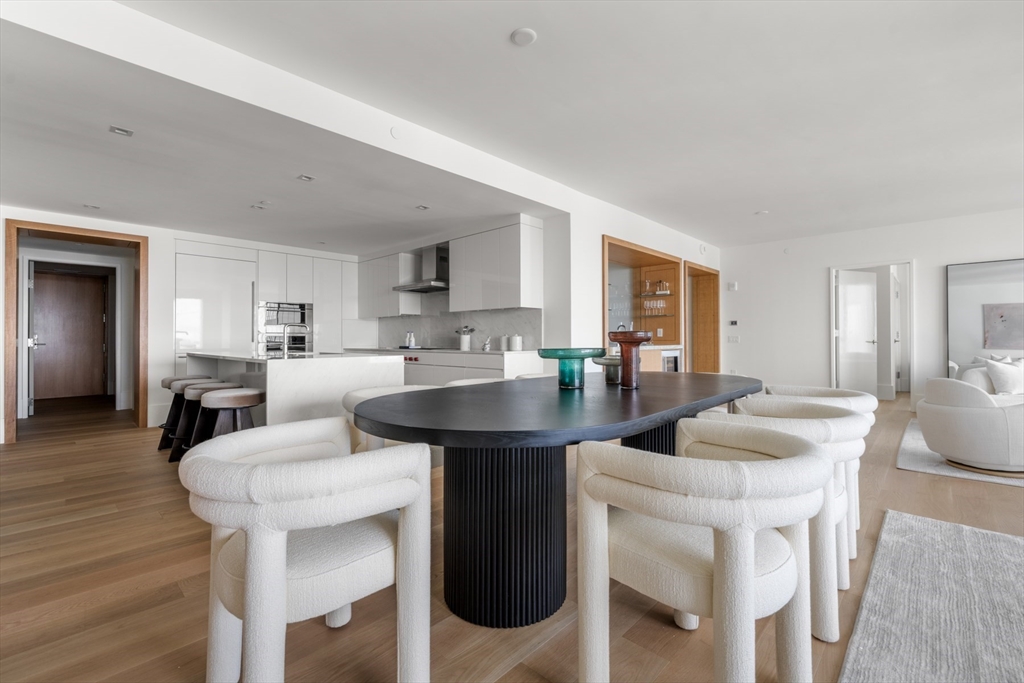 150 Seaport Boulevard, Unit 15CD Boston, MA 02210 - Photo 8 of 39 a living room with stainless steel appliances kitchen island granite countertop furniture and wooden floor