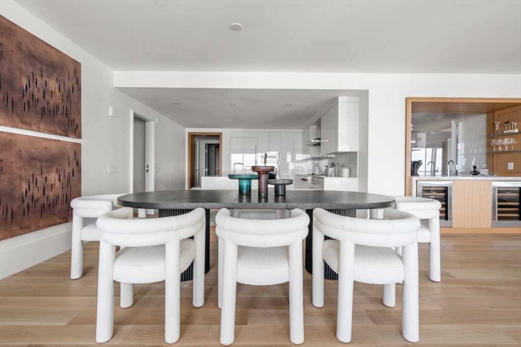 150 Seaport Boulevard, Unit 15CD Boston, MA 02210 - Photo 9 of 39 a dining room with furniture and wooden floor