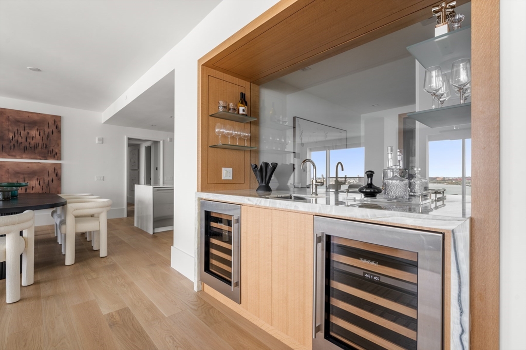 150 Seaport Boulevard, Unit 15CD Boston, MA 02210 - Photo 10 of 39 a kitchen with cabinets and chairs