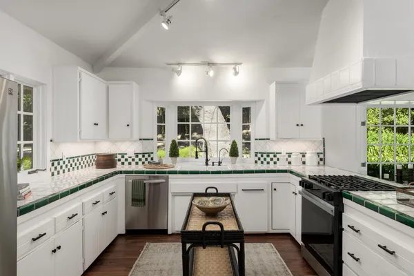 a kitchen with a sink stove and cabinets