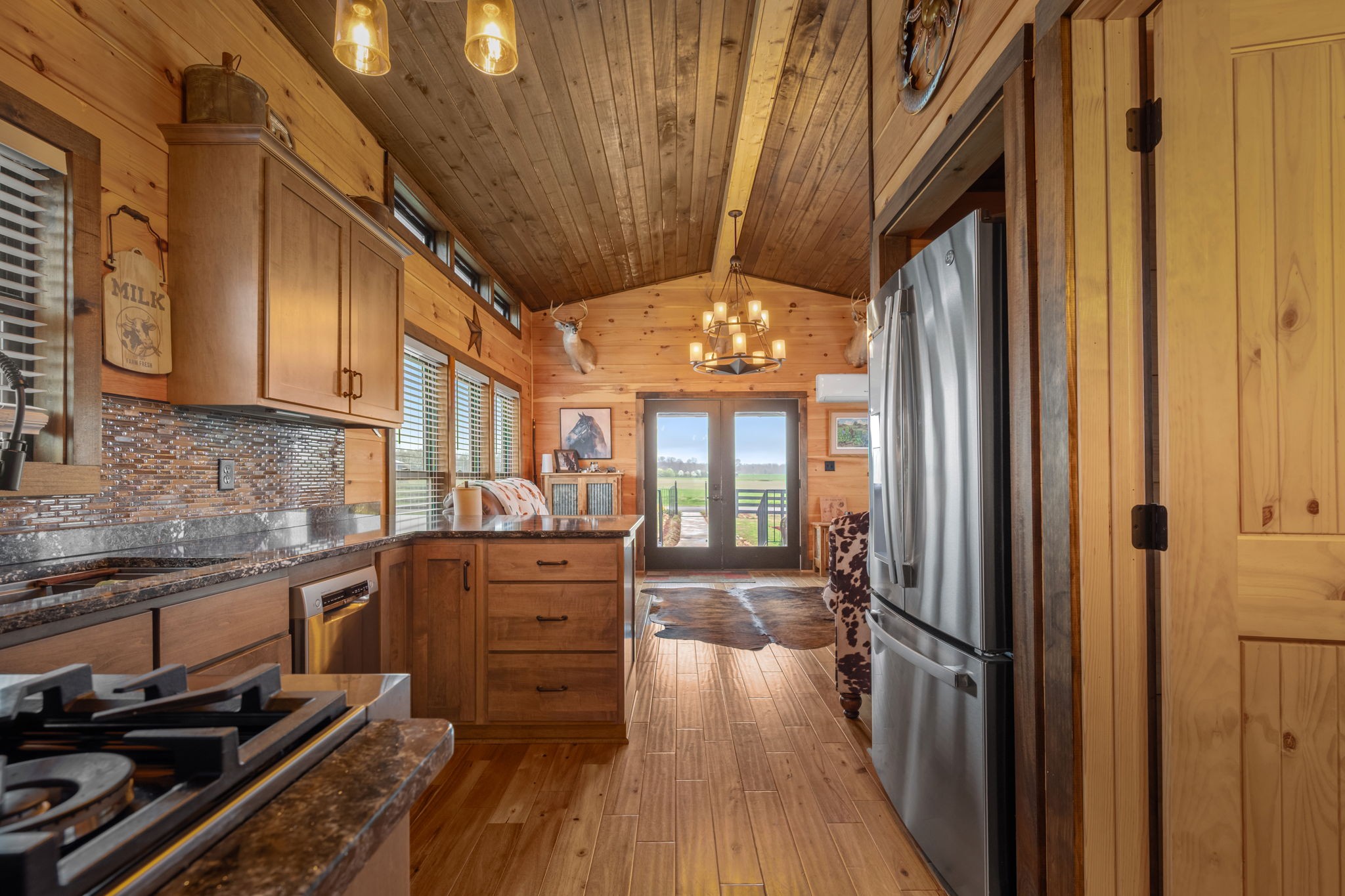 1765 Sugartree Springs Road Belvidere, TN 37306 - Photo 35 of 42 a kitchen with granite countertop wooden floors and stainless steel appliances