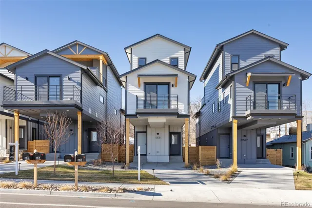 an empty room with windows and fireplace