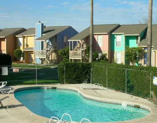6702 Everhart Road, Unit S101 Corpus Christi, TX 78413 - Photo 3 of 4 a swimming pool with outdoor seating and yard