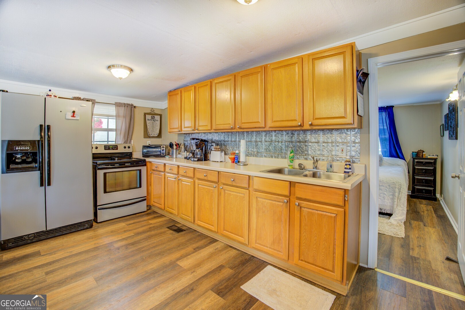 141 Andrea Circle Jackson, GA 30233 - Photo 12 of 41 a kitchen with stainless steel appliances a refrigerator sink and cabinets