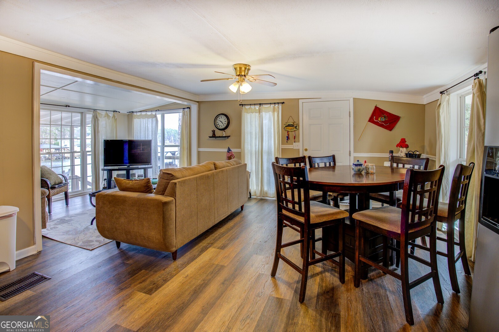 141 Andrea Circle Jackson, GA 30233 - Photo 15 of 41 a dining room with furniture a flat screen tv and wooden floor
