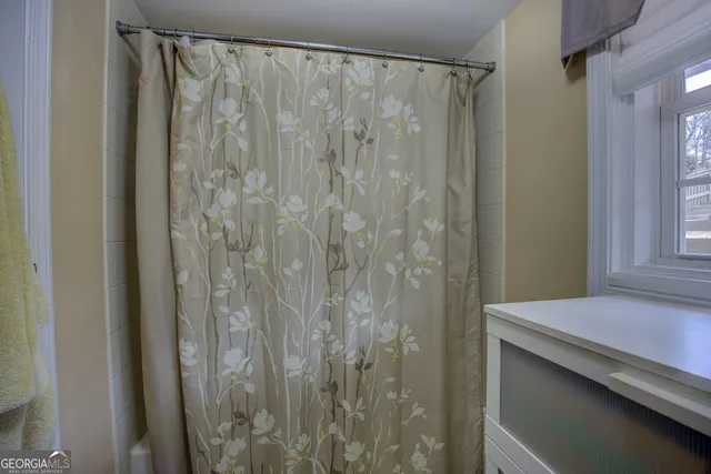 a bathroom with a shower and a mirror