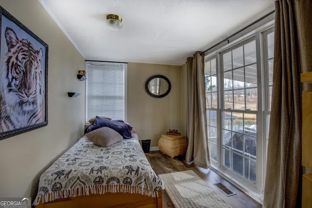 a bedroom with a bed and a window