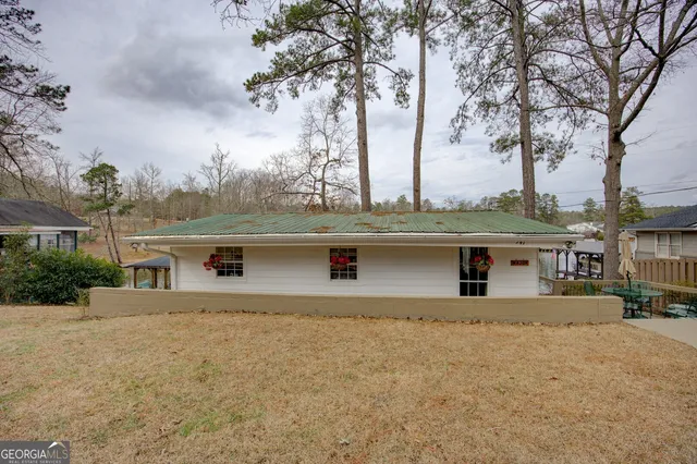 a view of a dining room with furniture a rug and wooden floor
