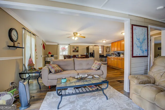 a living room with furniture and kitchen view