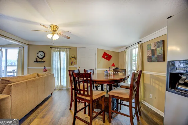 a view of a dining room with furniture and chandelier