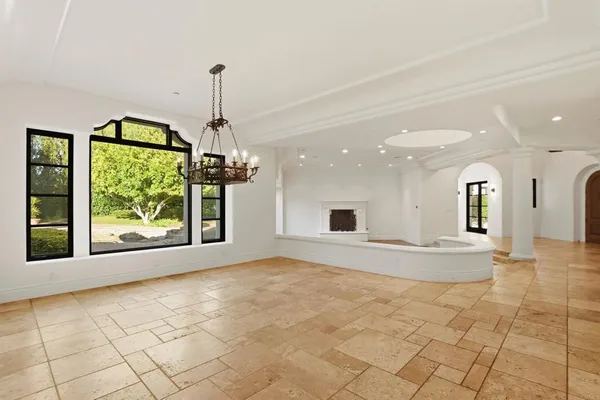 a kitchen with kitchen island granite countertop a sink a counter top space and cabinets
