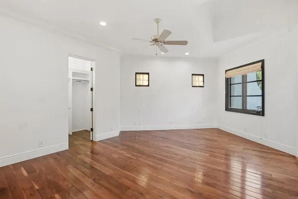 a view of room with stairs and a ceiling fan