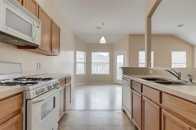 a kitchen with stainless steel appliances granite countertop a sink stove and cabinets