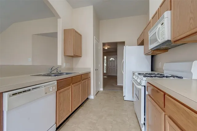 a kitchen with stainless steel appliances granite countertop a stove and a sink