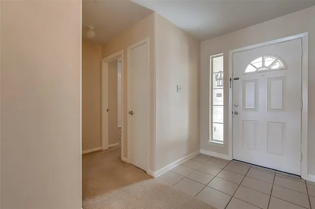an empty room with windows and wooden door