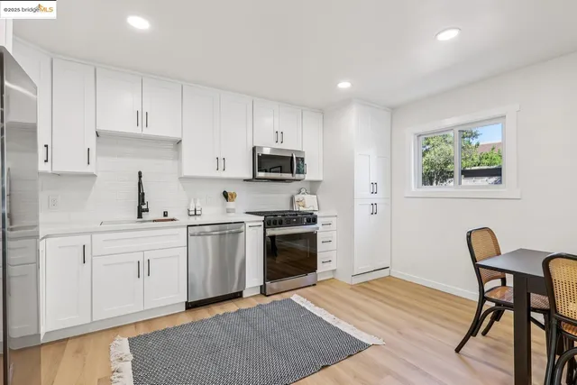 a kitchen with a stove top oven sink and cabinets