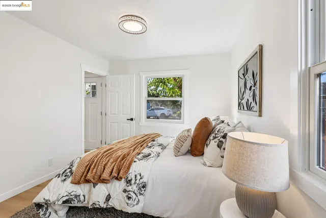 a bedroom with a bed and a painting on the wall