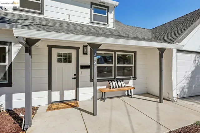 a view of a house with a balcony and furniture