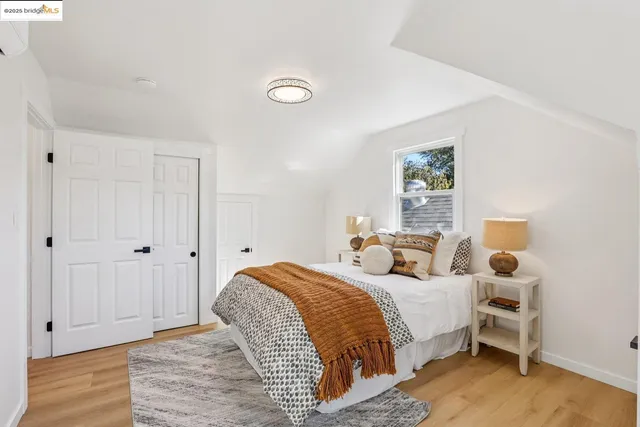 a bedroom with a bed and wooden floor