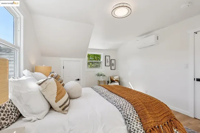 a bedroom with bed and a window