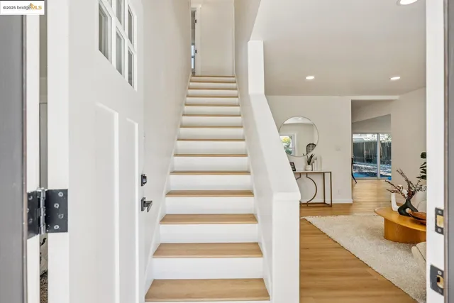 a view of entryway and hall with wooden floor