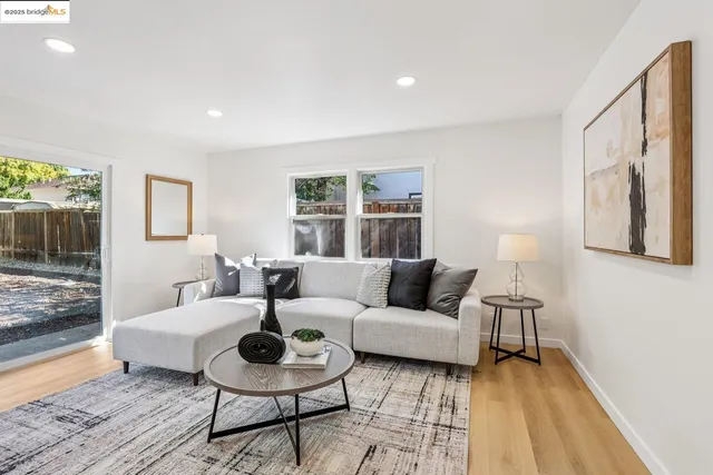 a living room with couches a coffee table and a coffee table with wooden floor