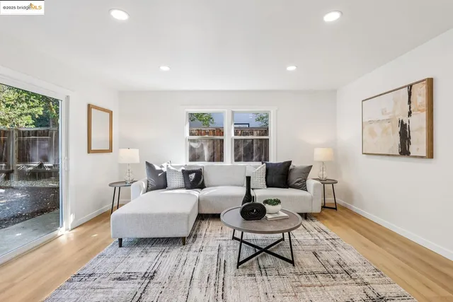 a living room with furniture wooden floor and a rug