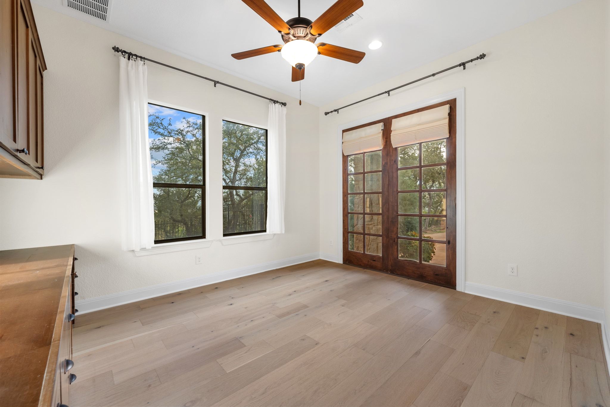 3701 Copper Ridge Court Austin, TX 78734 - Photo 12 of 30 a view of an empty room with a window and kitchen chandelier