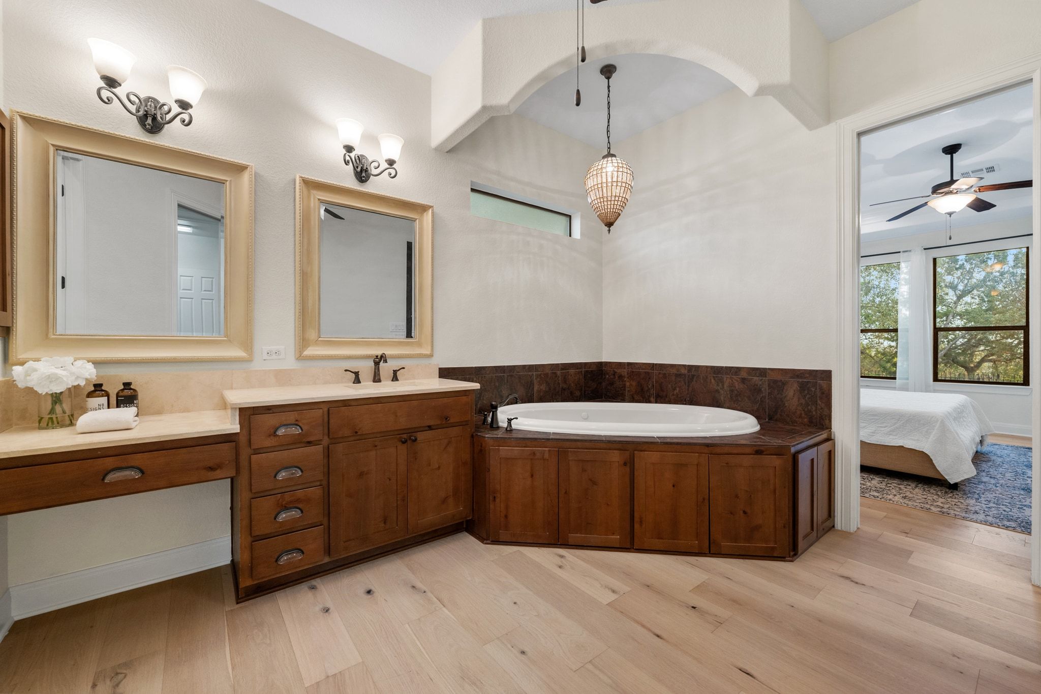 3701 Copper Ridge Court Austin, TX 78734 - Photo 14 of 30 a spacious bathroom with a double vanity sink a large mirror and a bathtub