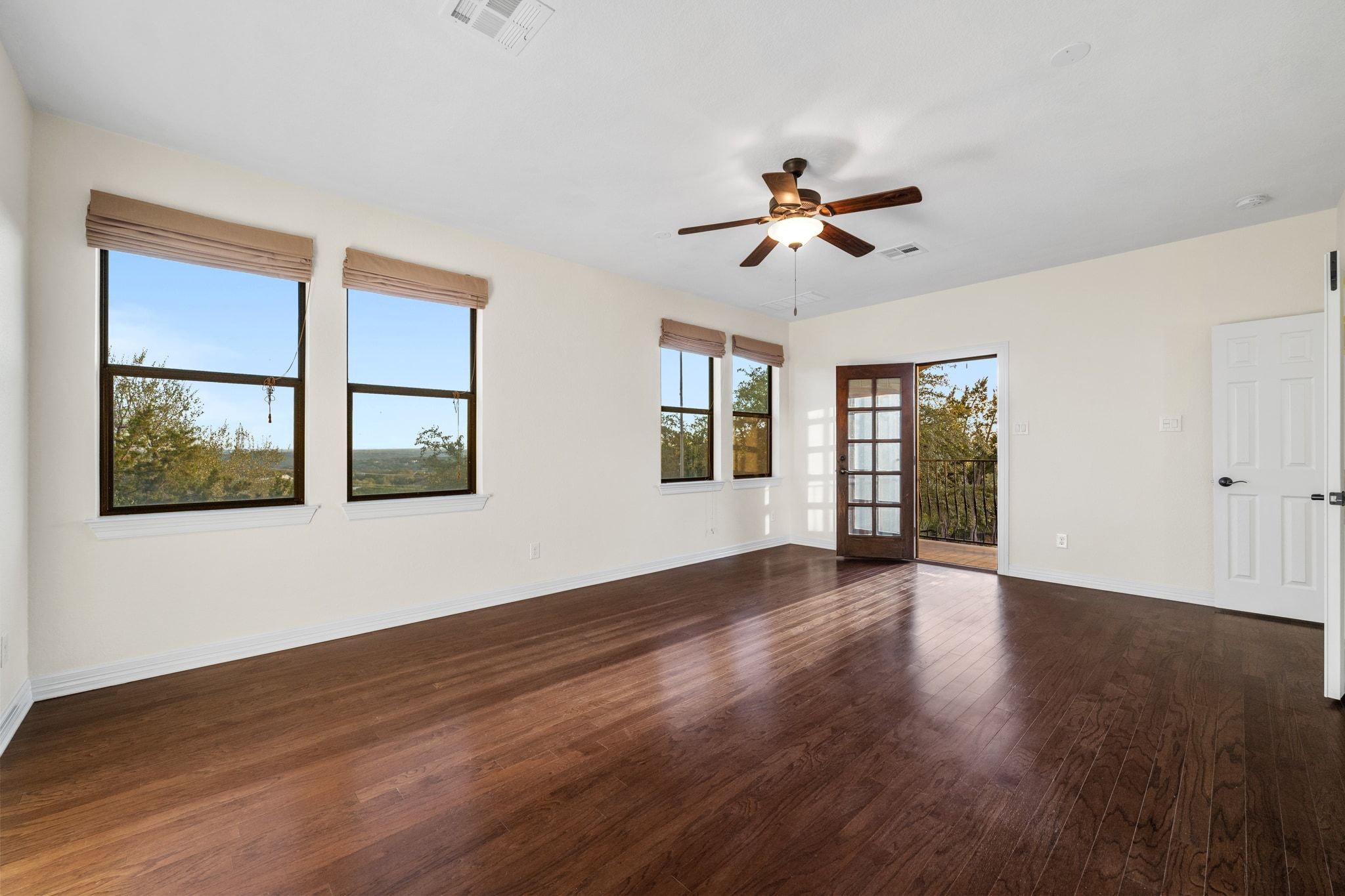 3701 Copper Ridge Court Austin, TX 78734 - Photo 17 of 30 a view of an empty room with window and wooden floor