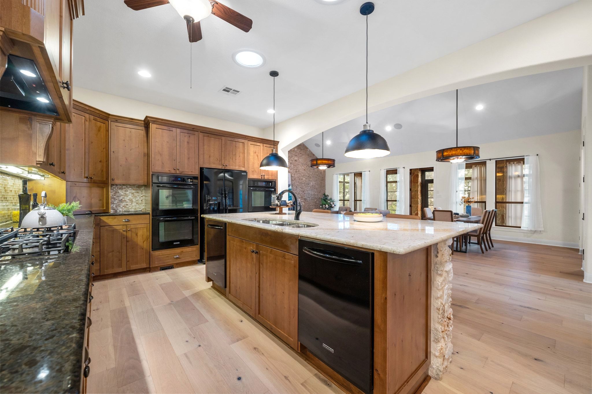 3701 Copper Ridge Court Austin, TX 78734 - Photo 9 of 30 a kitchen with stainless steel appliances granite countertop a sink a stove and a refrigerator