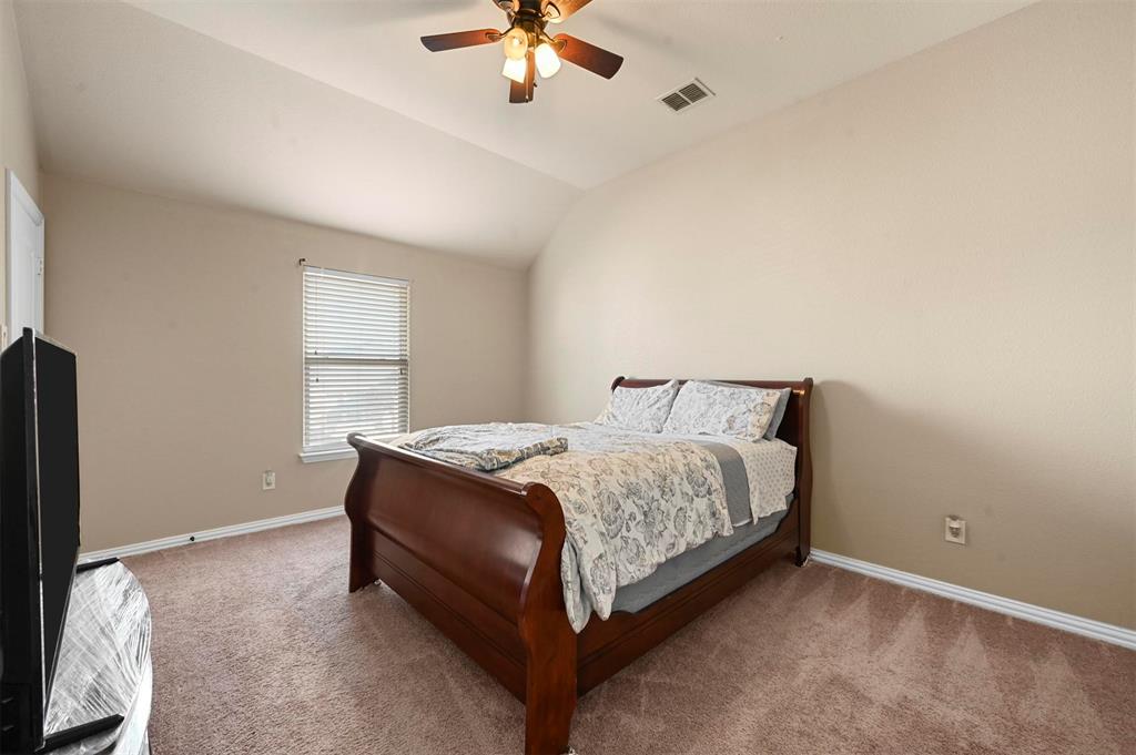 14815 Frisco Ranch Drive Little Elm, TX 75068 - Photo 29 of 40 a spacious bedroom with a bed and window