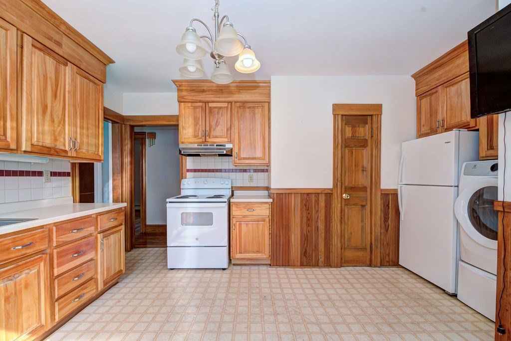 89-91 Larchwood Road Methuen, MA 01844 - Photo 17 of 39 a kitchen with stainless steel appliances granite countertop a refrigerator a stove and a sink with large windows