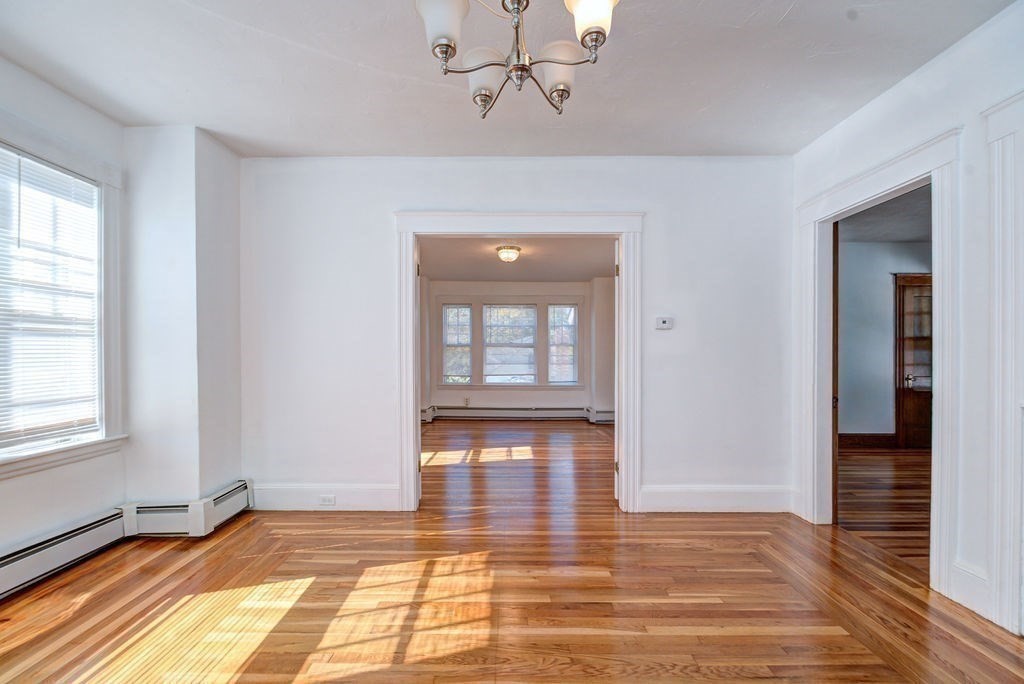 89-91 Larchwood Road Methuen, MA 01844 - Photo 23 of 39 wooden floor in an empty room with a window
