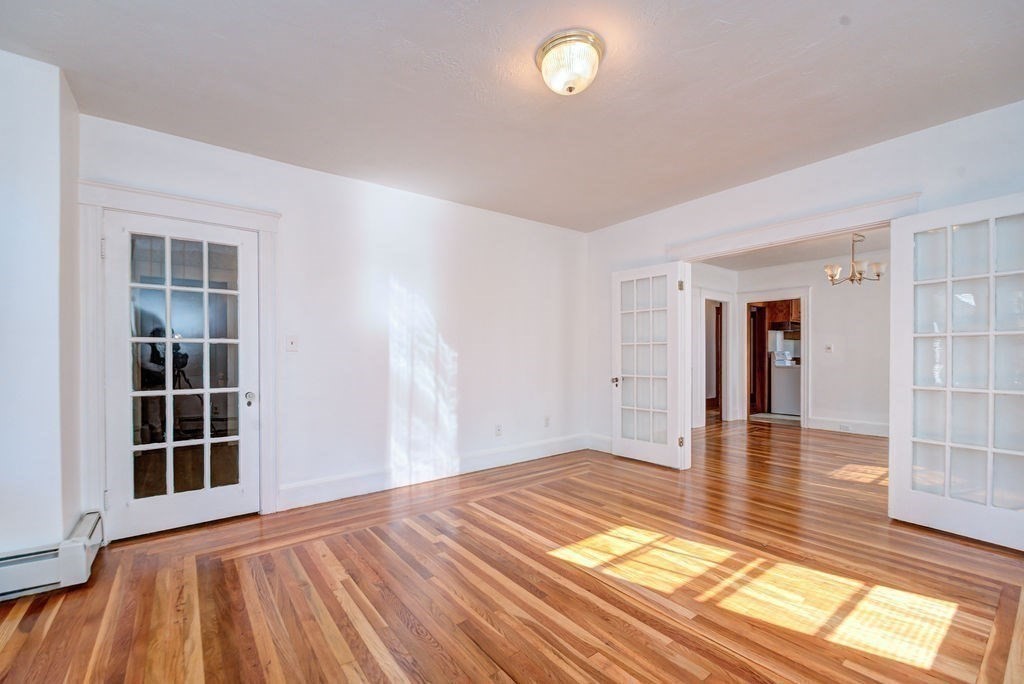 89-91 Larchwood Road Methuen, MA 01844 - Photo 27 of 39 an empty room with wooden floor and windows